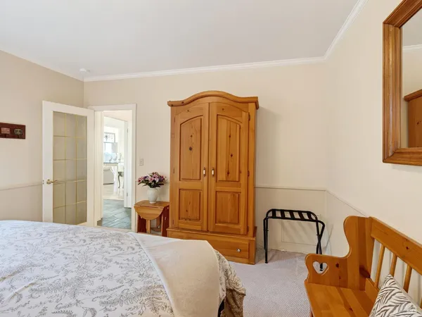 a bedroom with a bed and a dresser