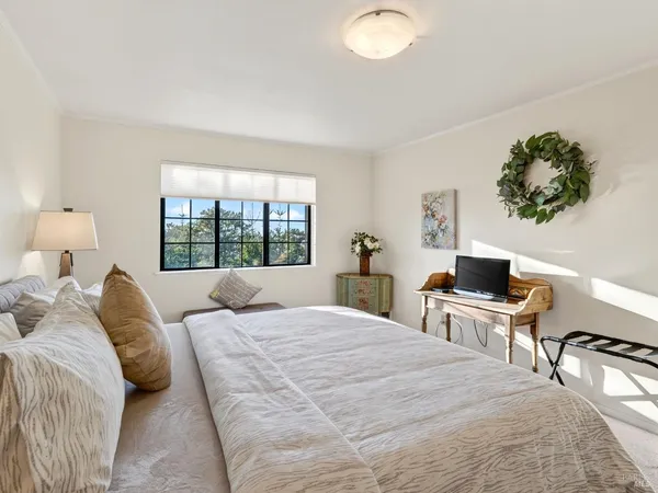 a bedroom with a large bed and a window