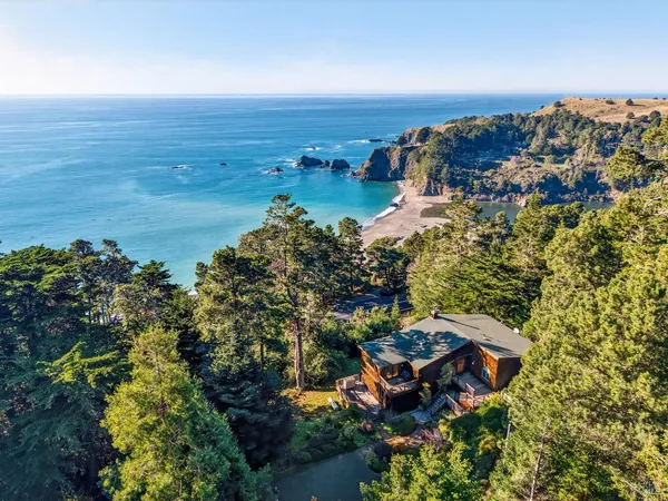 an aerial view of a house with a lake view