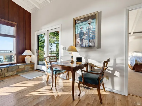 a view of a workspace with furniture and a window