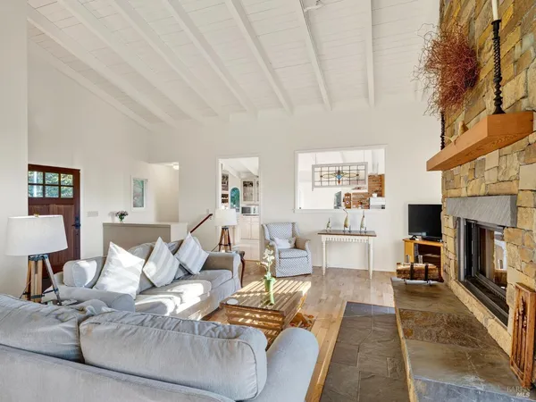 a living room with furniture a fireplace and a table