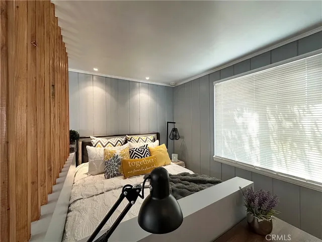 a bedroom with a bed and a window