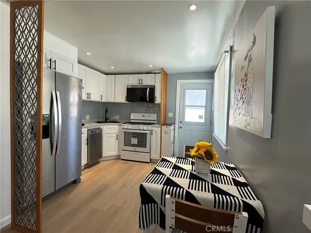 a kitchen with stainless steel appliances a refrigerator and a stove top oven