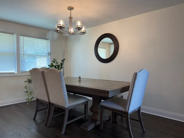 a view of a dining room with furniture and chandelier