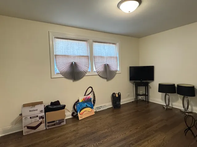 a room with wooden floor and lounge chair