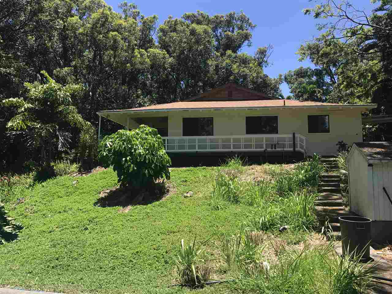 1825 Haiku Road Haiku, HI 96708 - Photo 3 of 24 a front view of house with yard and trees in the background