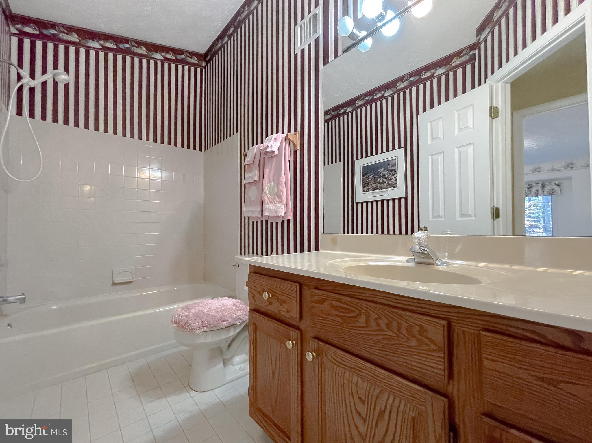 288 Elkins Lane Lusby, MD 20657 - Photo 21 of 73 a bathroom with a granite countertop sink a toilet and bathtub