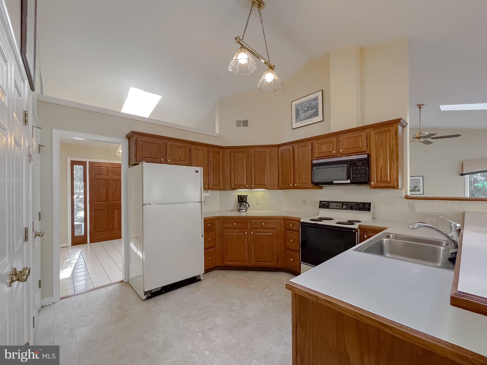 288 Elkins Lane Lusby, MD 20657 - Photo 35 of 73 a kitchen with stainless steel appliances granite countertop a refrigerator stove microwave sink and cabinets