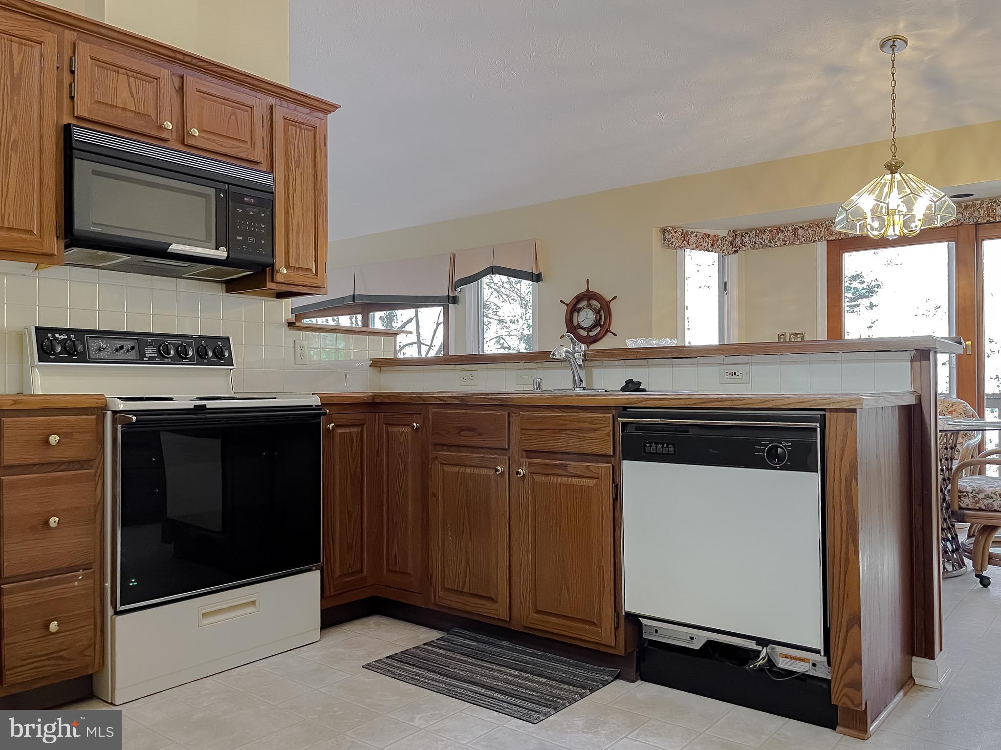 288 Elkins Lane Lusby, MD 20657 - Photo 36 of 73 a kitchen with granite countertop a stove and a microwave
