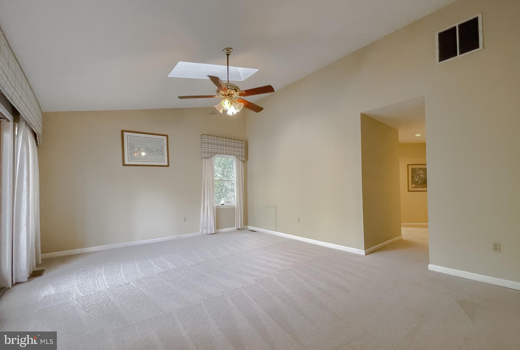 288 Elkins Lane Lusby, MD 20657 - Photo 39 of 73 an empty room with a chandelier fan and windows