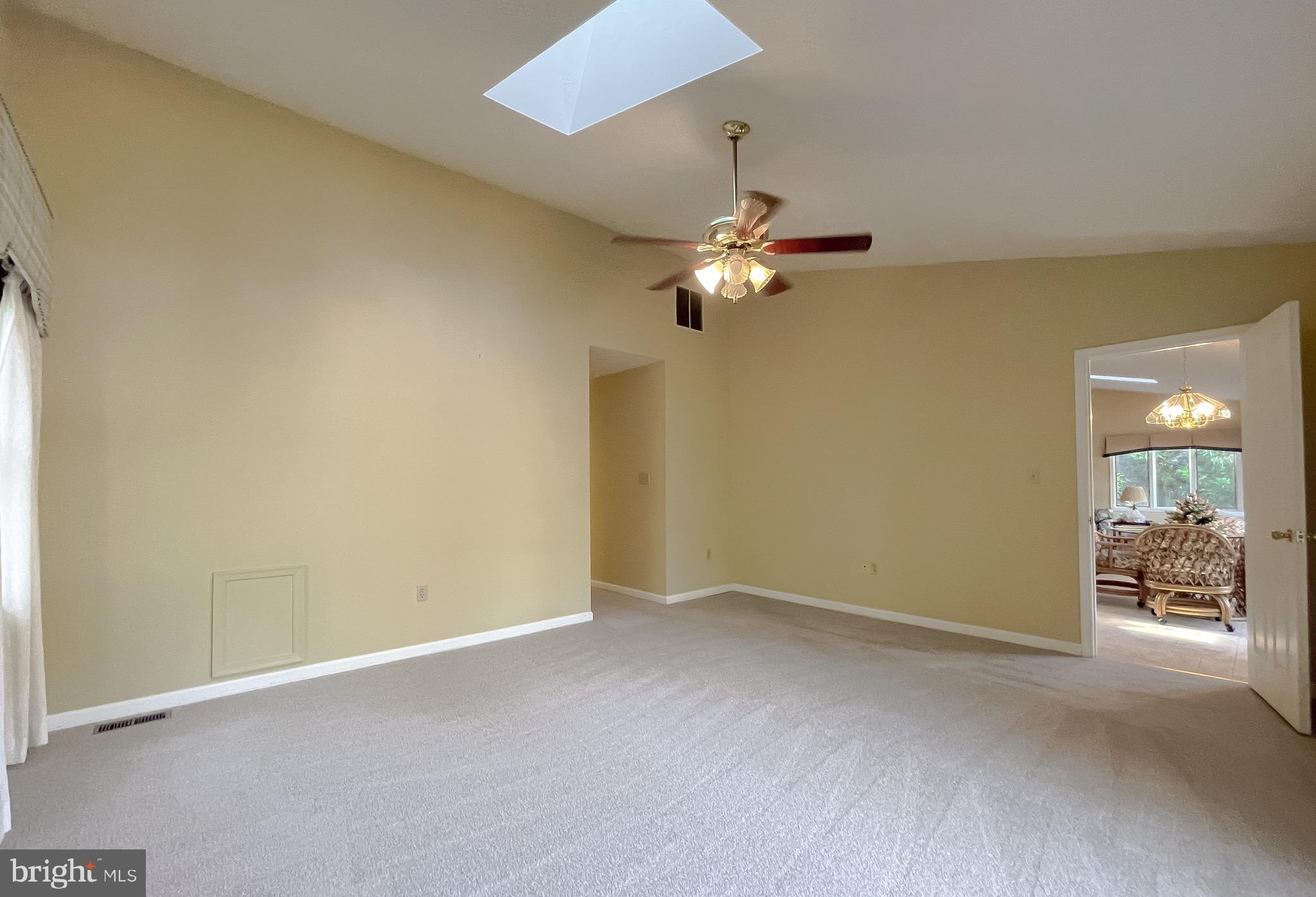 288 Elkins Lane Lusby, MD 20657 - Photo 42 of 73 an empty room with a chandelier fan and a large window