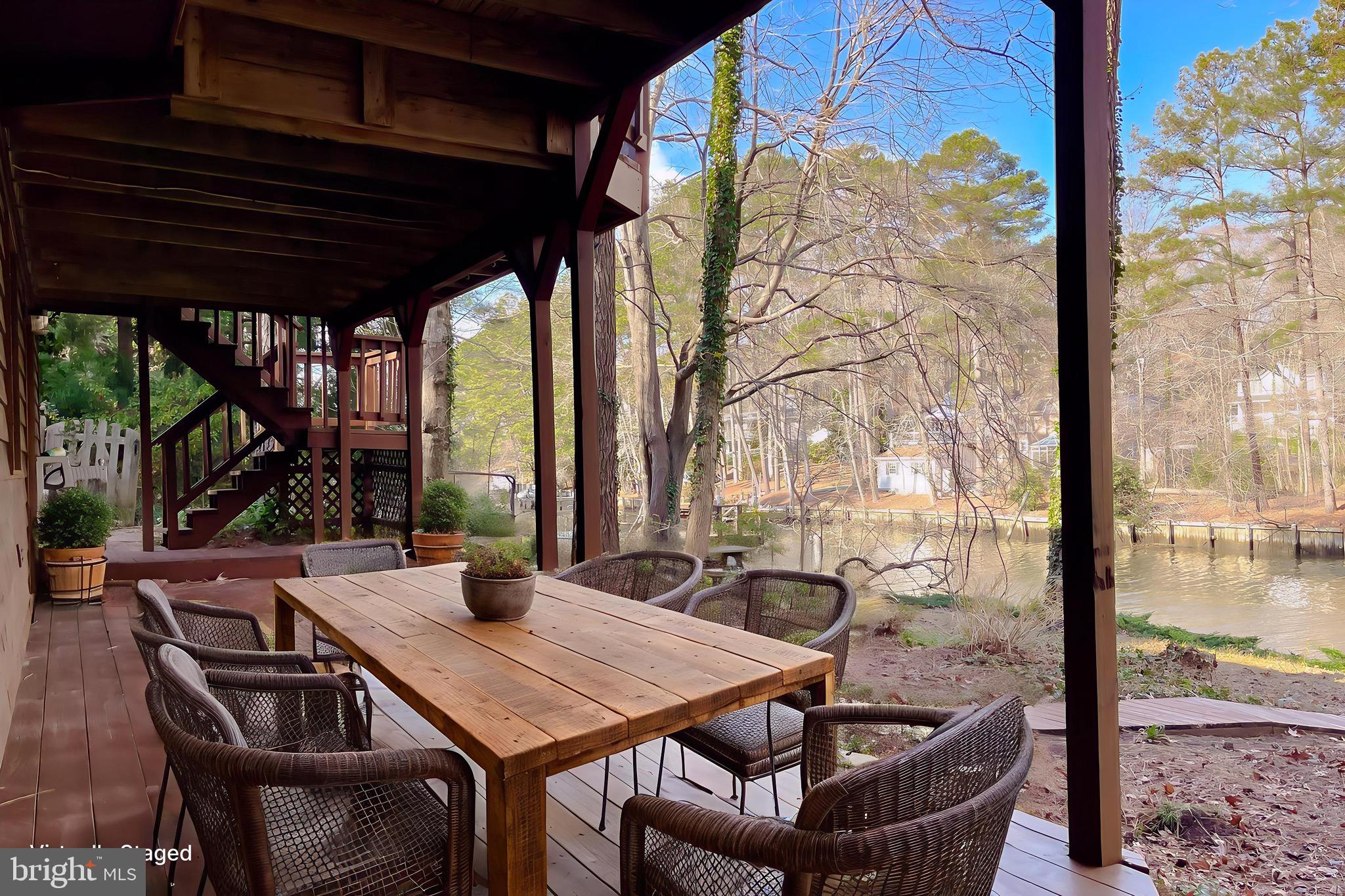 288 Elkins Lane Lusby, MD 20657 - Photo 72 of 73 a view of a patio with table and chairs and potted plants