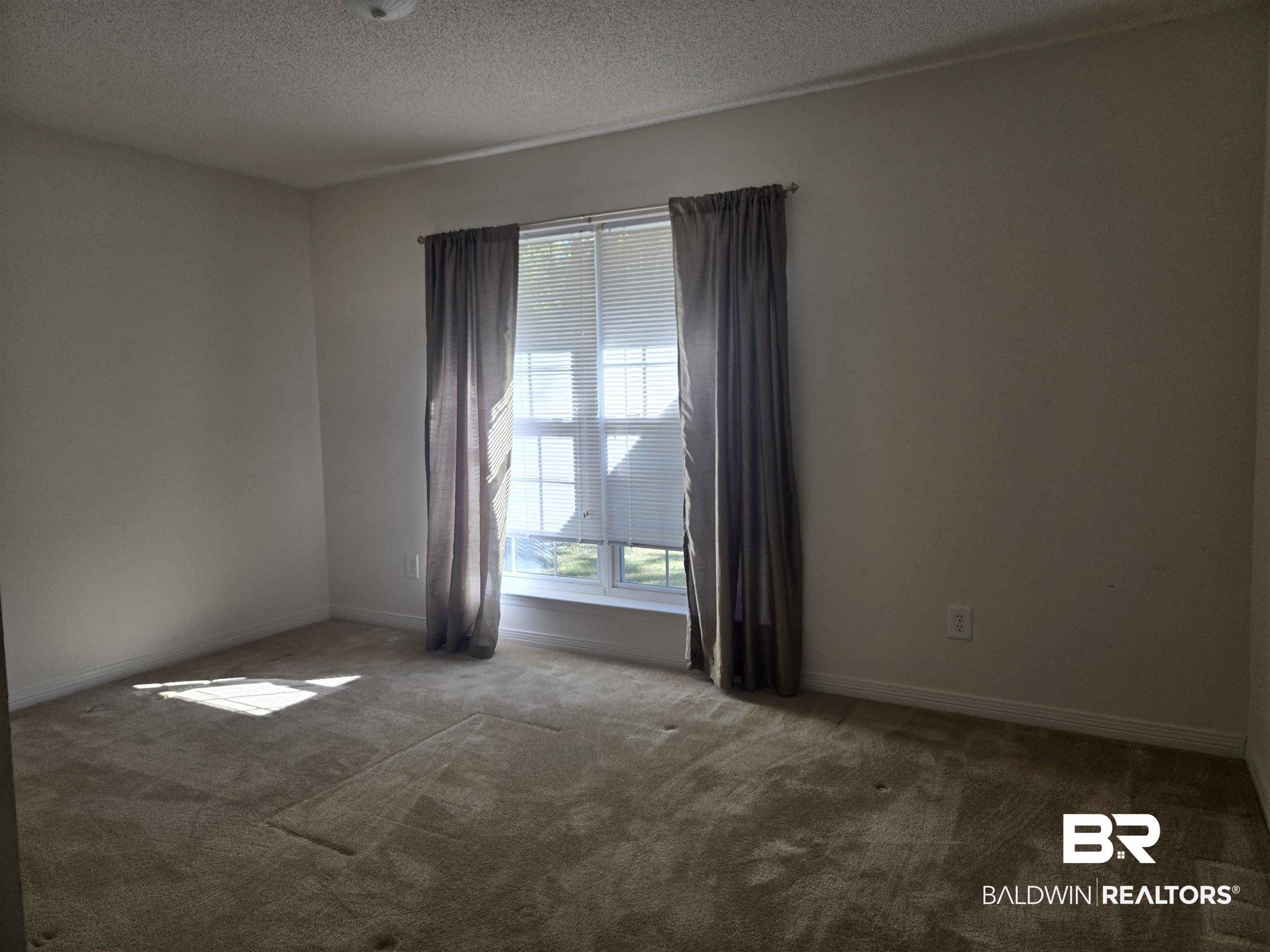 2554 Riverside Drive Mobile, AL 36605 - Photo 24 of 43 Spare room with carpet and a textured ceiling