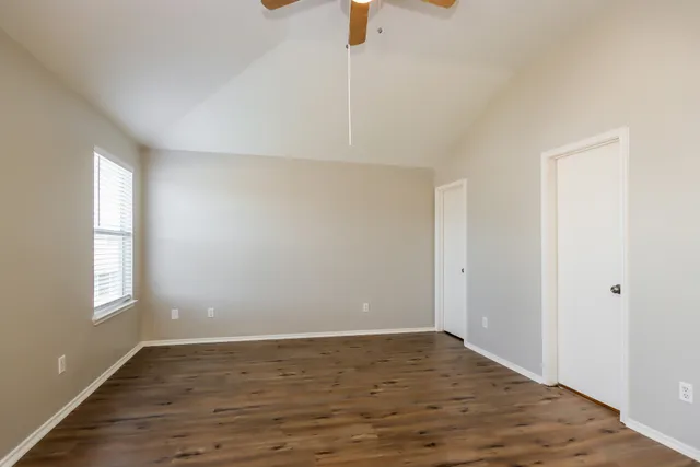 wooden floor in an empty room with a window