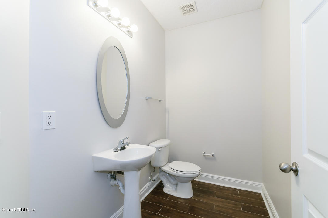 5663 Greenland Road, Unit 1008 Jacksonville, FL 32258 - Photo 11 of 24 a bathroom with a sink toilet and a mirror