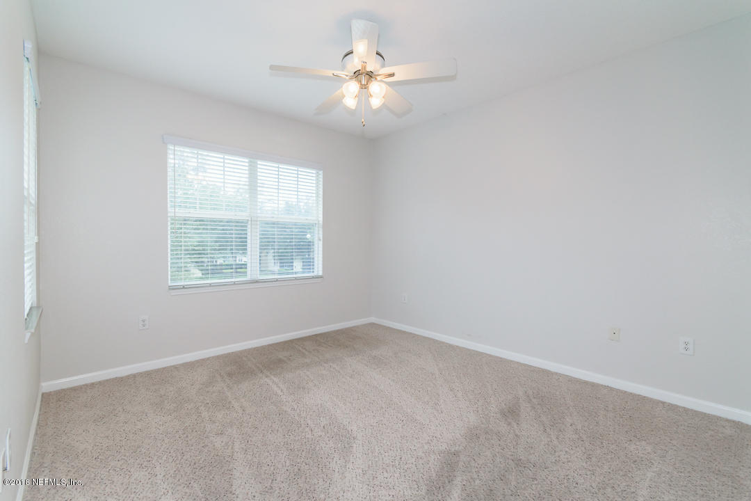 5663 Greenland Road, Unit 1008 Jacksonville, FL 32258 - Photo 13 of 24 an empty room with windows and ceiling fan