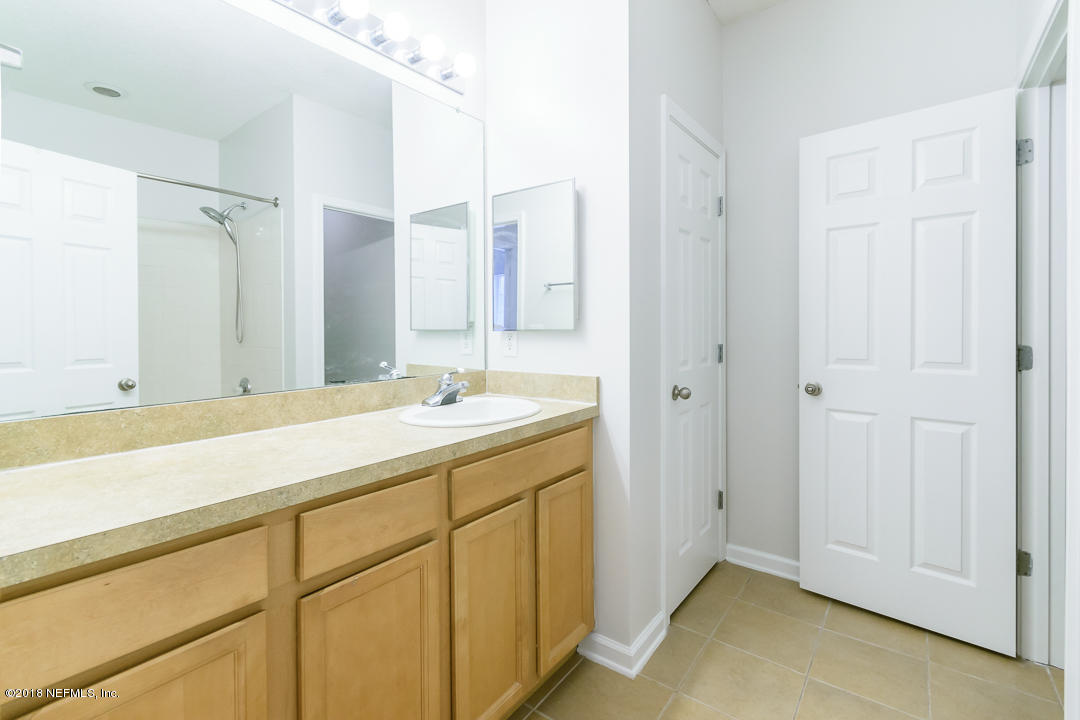 5663 Greenland Road, Unit 1008 Jacksonville, FL 32258 - Photo 14 of 24 a bathroom with a sink and a mirror