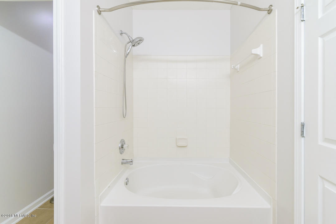 5663 Greenland Road, Unit 1008 Jacksonville, FL 32258 - Photo 15 of 24 a close up of a bathtub curtain