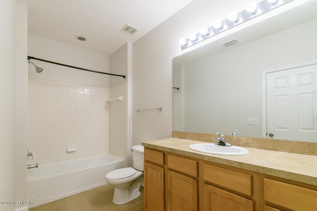 5663 Greenland Road, Unit 1008 Jacksonville, FL 32258 - Photo 18 of 24 a bathroom with a sink toilet and shower