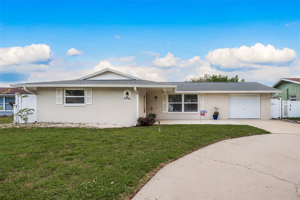 a front view of a house with a garden and yard