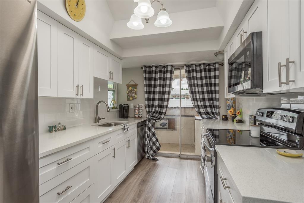 8906 Catalina Drive Port Richey, FL 34668 - Photo 12 of 34 a kitchen with a stove a sink and a refrigerator