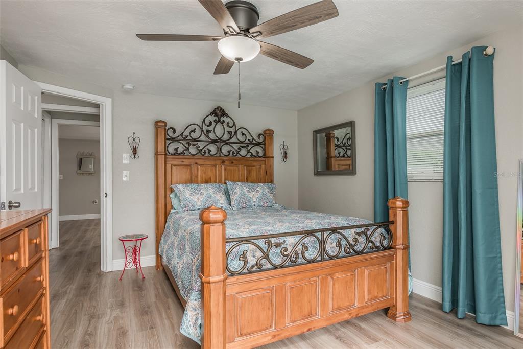 8906 Catalina Drive Port Richey, FL 34668 - Photo 14 of 34 a bedroom with a bed mirror and a window