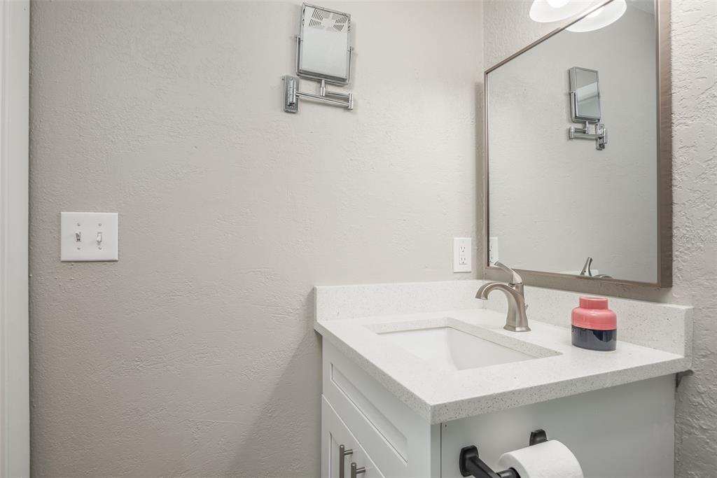 8906 Catalina Drive Port Richey, FL 34668 - Photo 16 of 34 a bathroom with a sink and a mirror