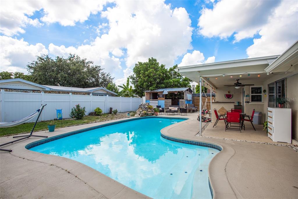 8906 Catalina Drive Port Richey, FL 34668 - Photo 2 of 34 a view of a swimming pool with furniture