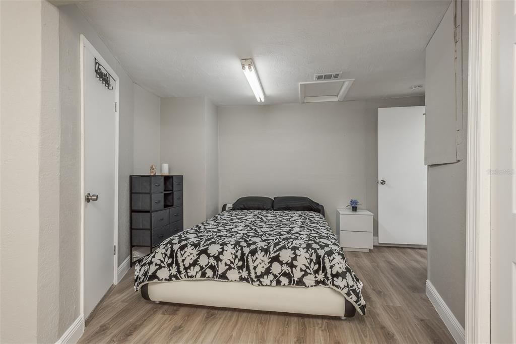 8906 Catalina Drive Port Richey, FL 34668 - Photo 22 of 34 a bedroom with a bed and a window