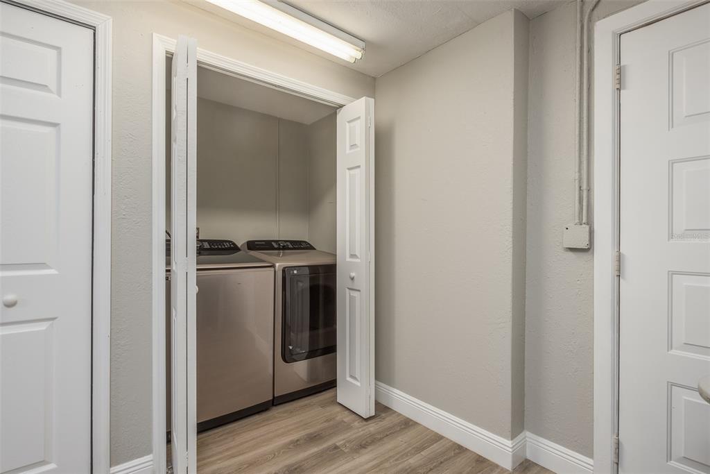 8906 Catalina Drive Port Richey, FL 34668 - Photo 23 of 34 a view of walk in closet with wooden floor
