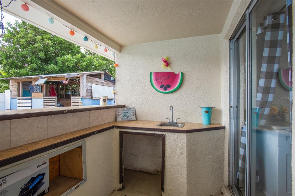 8906 Catalina Drive Port Richey, FL 34668 - Photo 26 of 34 a kitchen with a sink cabinets and window