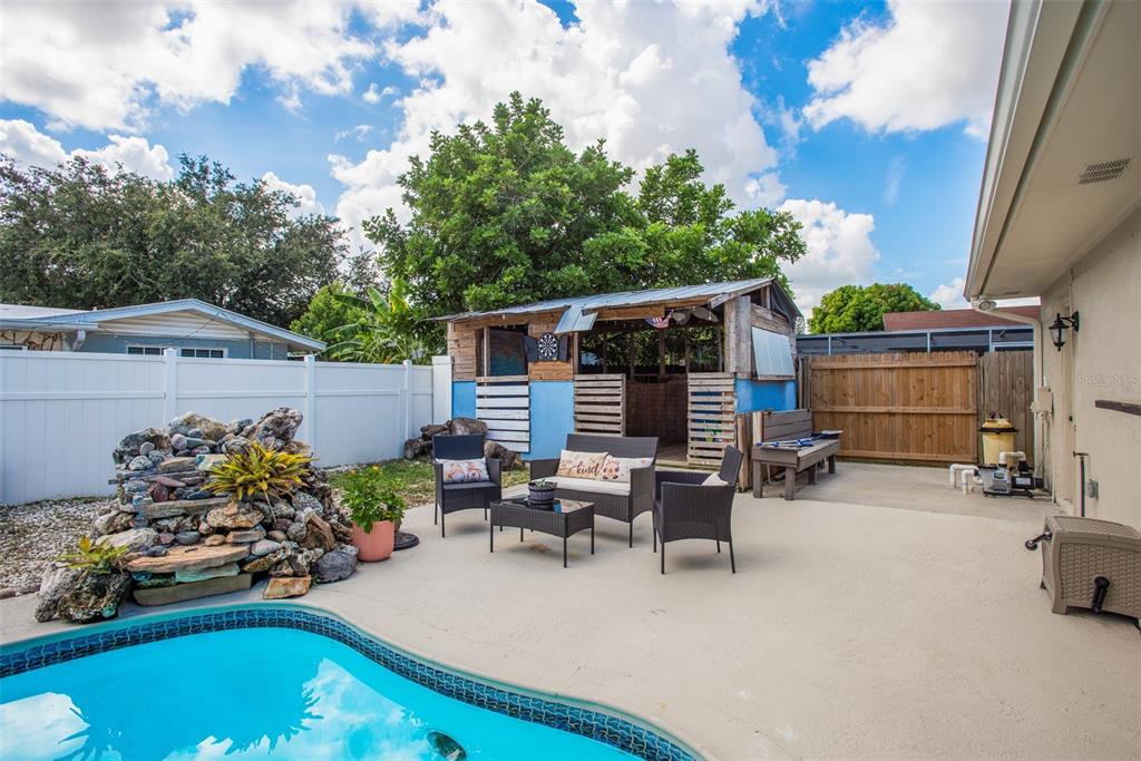 8906 Catalina Drive Port Richey, FL 34668 - Photo 27 of 34 a roof deck with table and chairs and potted plants