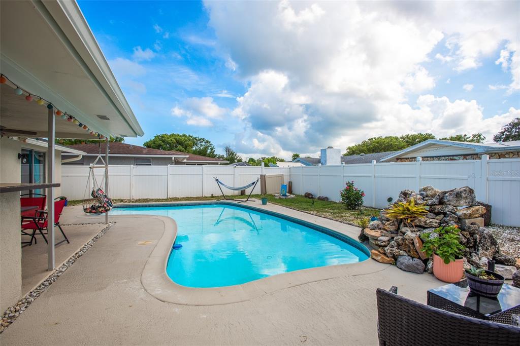 8906 Catalina Drive Port Richey, FL 34668 - Photo 29 of 34 a view of a swimming pool with a patio