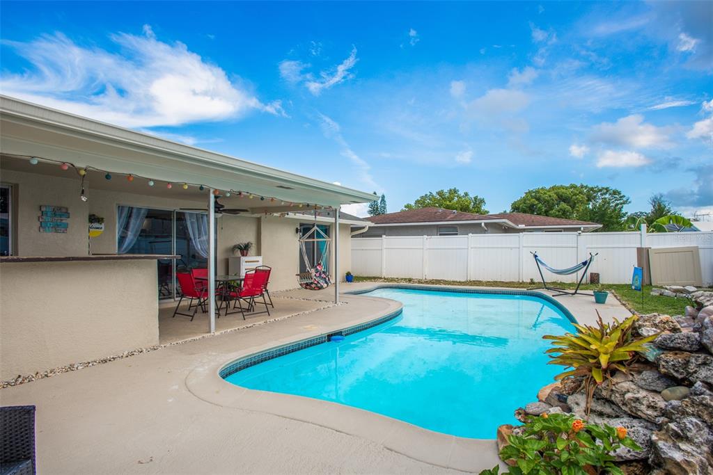 8906 Catalina Drive Port Richey, FL 34668 - Photo 30 of 34 a view of a chairs and table in a patio