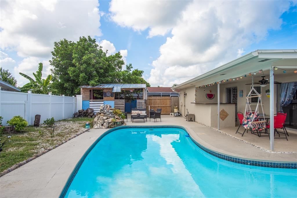 8906 Catalina Drive Port Richey, FL 34668 - Photo 32 of 34 a view of a house with backyard patio and sitting area