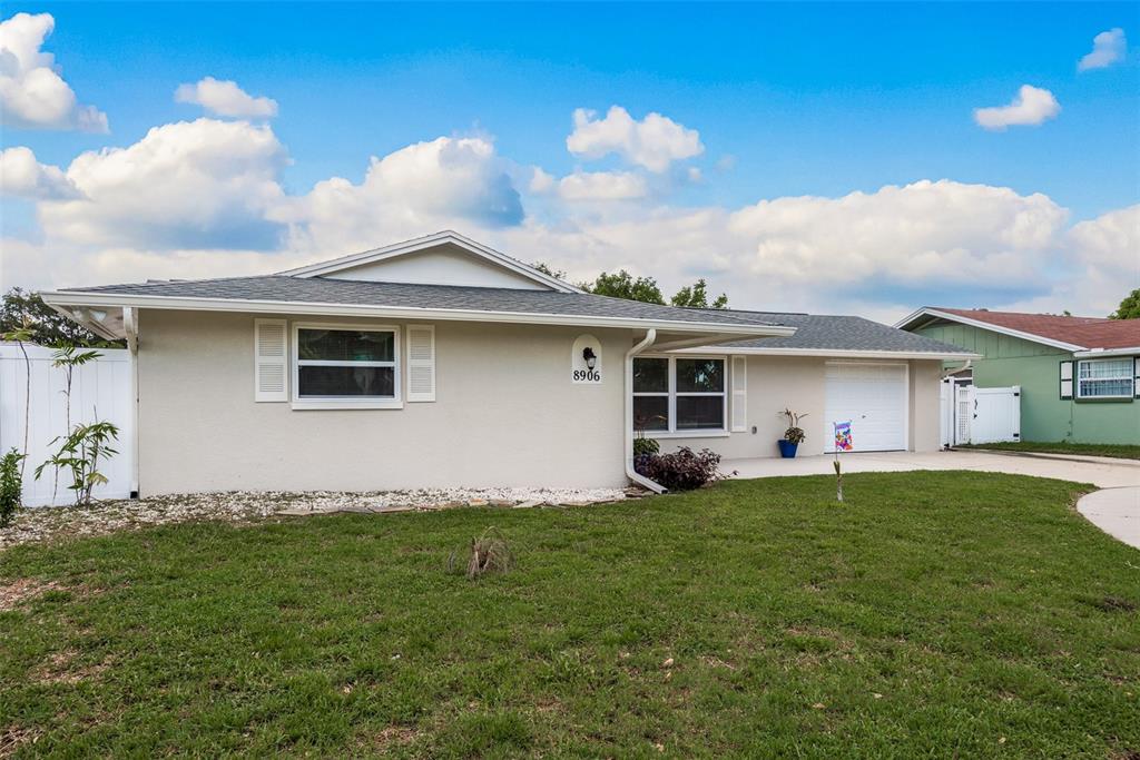 8906 Catalina Drive Port Richey, FL 34668 - Photo 34 of 34 a front view of house with yard and outdoor seating