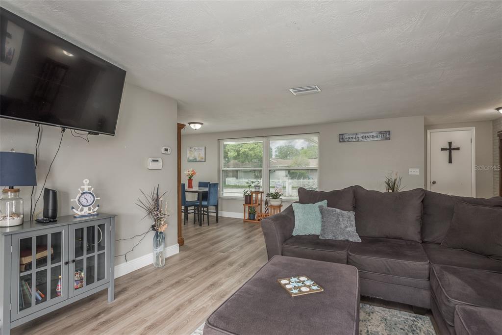 8906 Catalina Drive Port Richey, FL 34668 - Photo 5 of 34 a living room with furniture and a flat screen tv