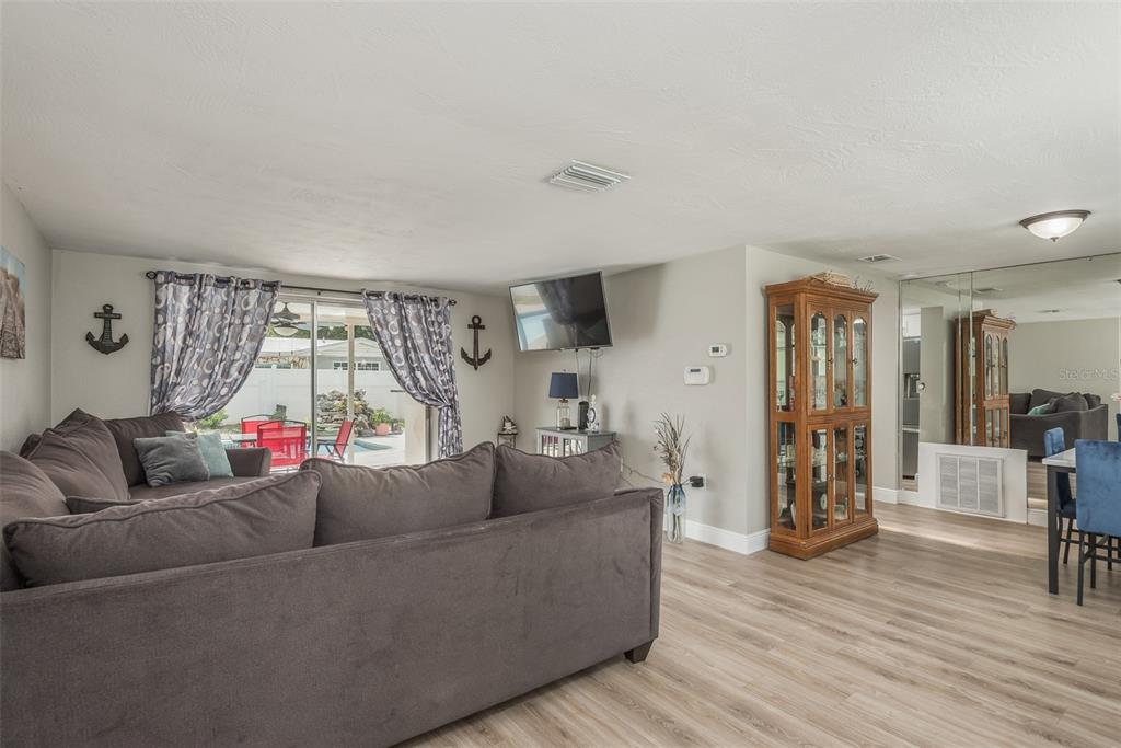 8906 Catalina Drive Port Richey, FL 34668 - Photo 6 of 34 a living room with furniture and a wooden floor