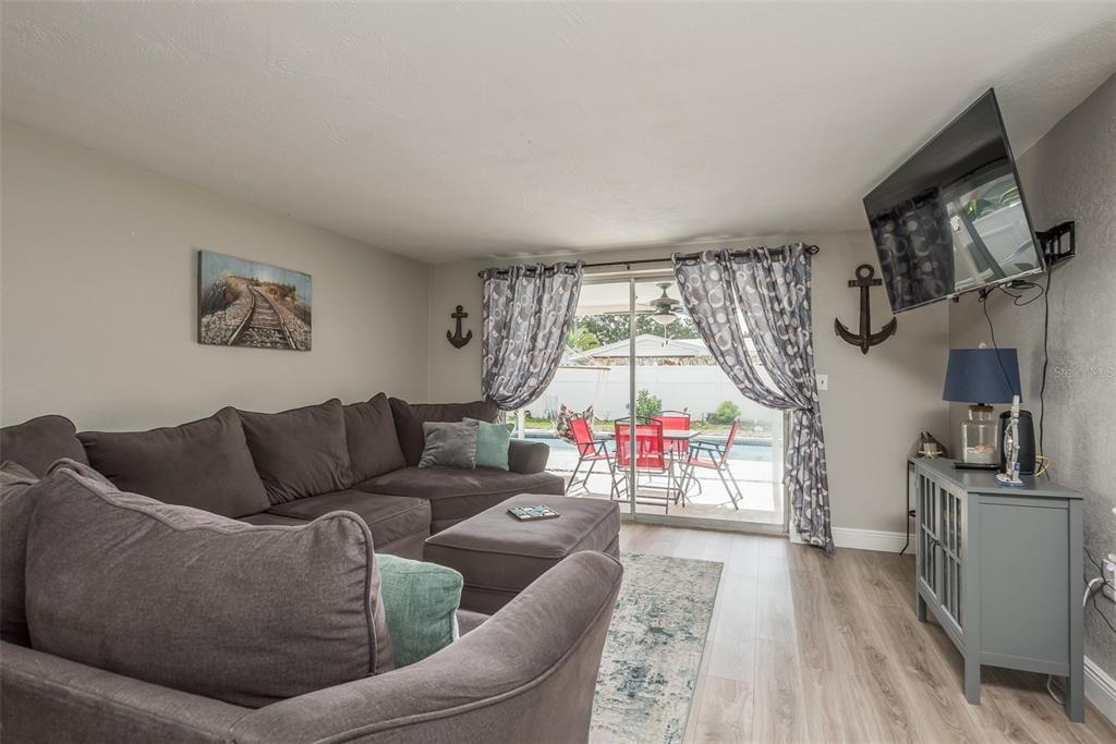 8906 Catalina Drive Port Richey, FL 34668 - Photo 7 of 34 a living room with furniture and a flat screen tv
