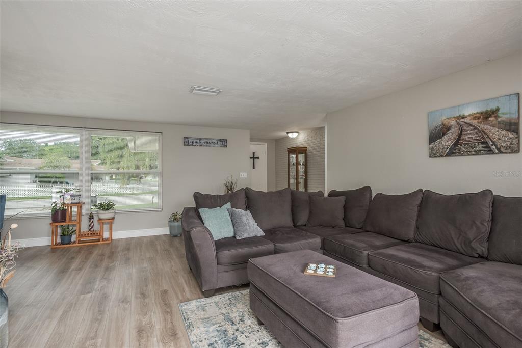 8906 Catalina Drive Port Richey, FL 34668 - Photo 8 of 34 a living room with furniture and a large window