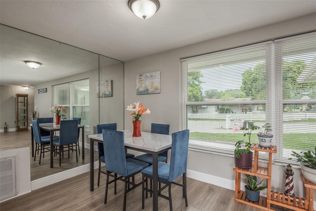 8906 Catalina Drive Port Richey, FL 34668 - Photo 9 of 34 a view of a dining room with furniture window and wooden floor
