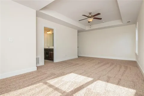 an empty room with fan and ceiling fan
