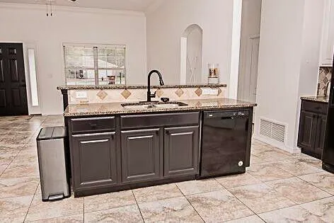 a kitchen with stainless steel appliances granite countertop a sink stove and cabinets