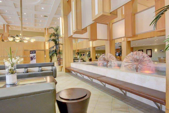 a lobby with furniture and floor to ceiling windows