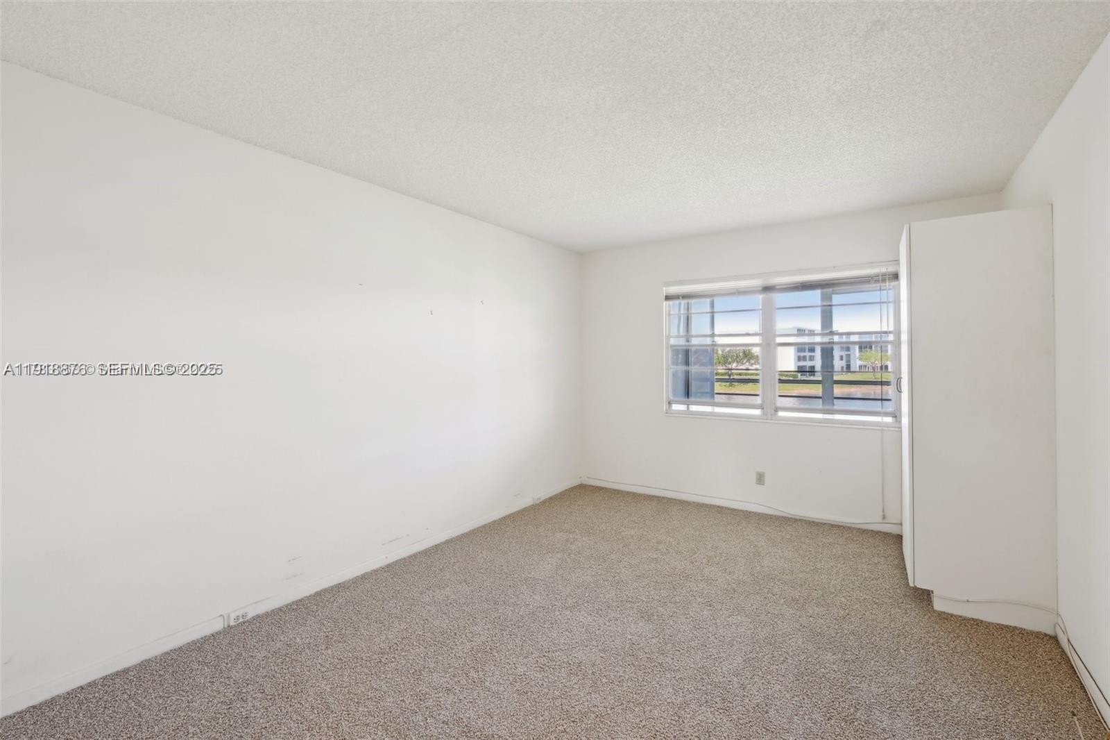 2052 Exeter C, Unit 2052 Boca Raton, FL 33434 - Photo 8 of 35 a view of an empty room with a window