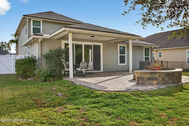 a view of a house with backyard and sitting area