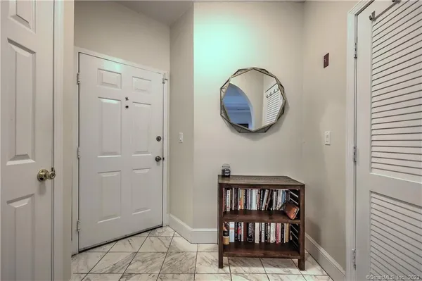 a living room with furniture kitchen view and a flat screen tv