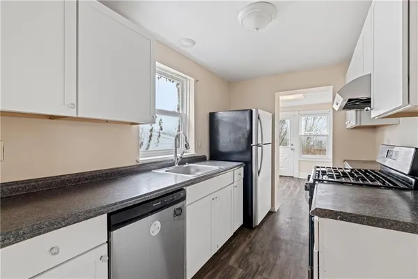 a kitchen with a sink stove and refrigerator