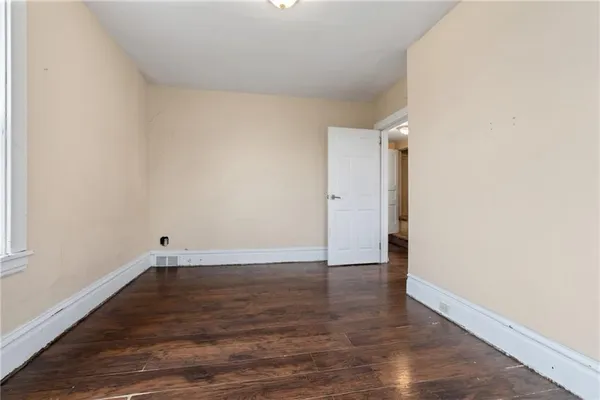 a view of an empty room and wooden floor
