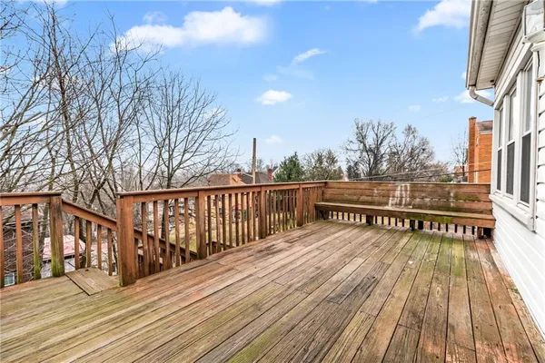 a view of balcony with wooden floor and fence